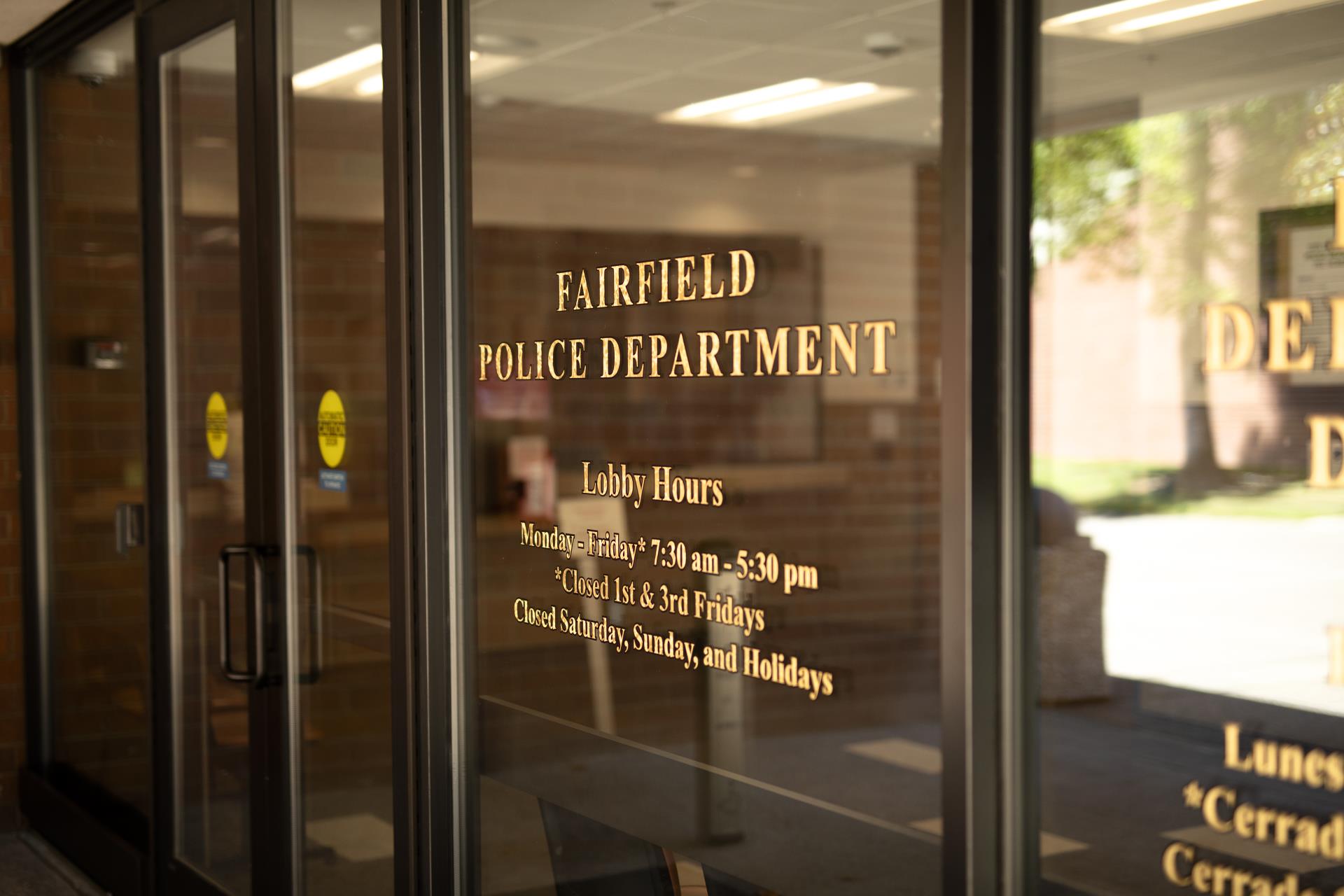Image of Lobby Window with Police Department Hours