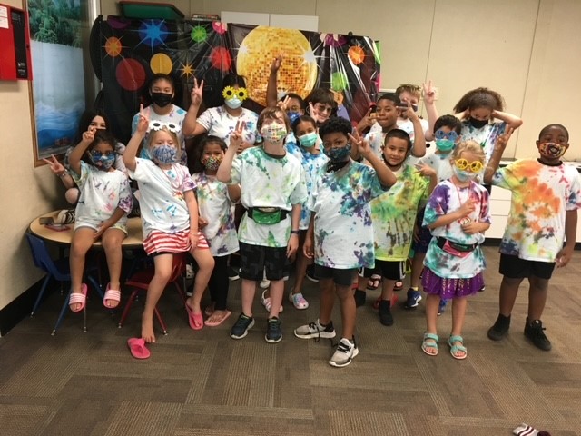Group of children wearing tye dye shirts