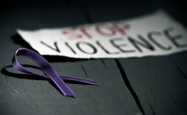 Stock photo of a stop violence message with a purple ribbon