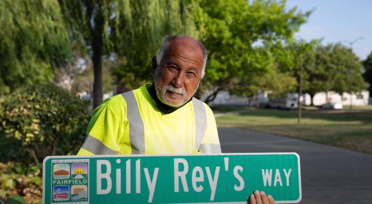 Bill Rey holding sign